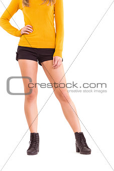 Lower half of woman in boots and shorts