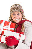 Happy blonde in winter clothes holding gifts