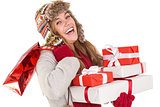 Happy blonde in winter clothes holding gifts