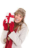 Happy blonde in winter clothes holding gift