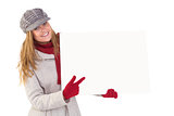 Happy blonde in winter clothes showing card