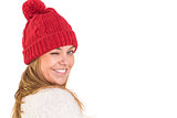Happy blonde in winter clothes winking
