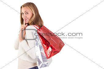 Pretty blonde keeping a secret holding bags
