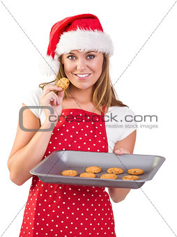 Festive homemaker showing hot cookies