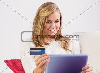 Pretty blonde shopping online with tablet pc