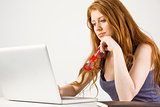 Pretty redhead working on laptop