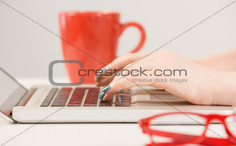 Female hands typing on laptop