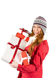 Pretty redhead in warm clothing holding gifts