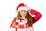 Festive stressed redhead holding gifts