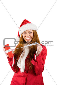 Festive redhead opening a gift