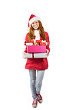 Festive redhead holding pile of gifts
