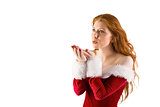 Festive redhead blowing over hands