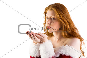 Festive redhead blowing over hands