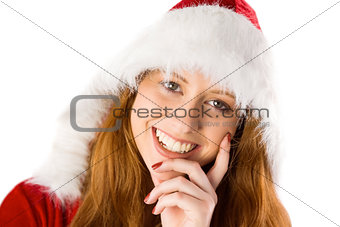 Festive redhead with hand on chin