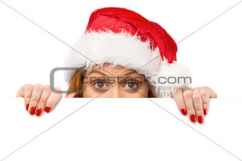 Festive redhead smiling at camera holding poster