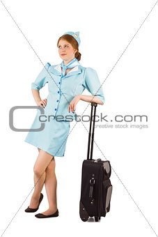 Pretty air hostess leaning on suitcase