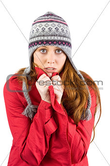 Cold redhead wearing coat and hat