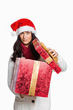 Confused woman opening christmas present