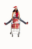 Woman jumping with shopping trolley