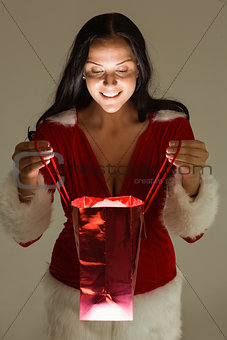 Smiling woman opening christmas present