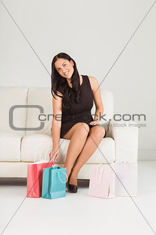 Woman sitting with shopping bags