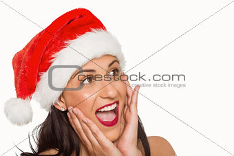 Surprised woman wearing santa hat