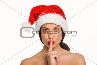 Woman with finger against lips