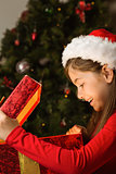 Little girl opening a magical christmas gift