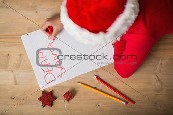 Little girl writing letter to santa at christmas