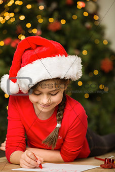 Little girl writing letter to santa at christmas