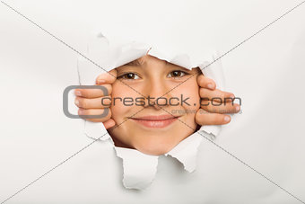 Cute little girl peeking through paper