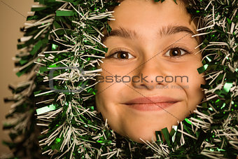 Cute little girl with tinsel around her head