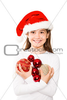 Festive little girl smiling at camera holding baubles