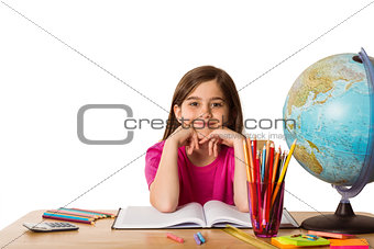 Cute pupil working at her desk