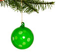 Green christmas decoration hanging from branch