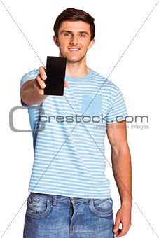 Young man showing phone to camera