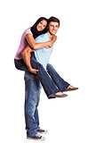 Young man giving girlfriend a piggyback ride