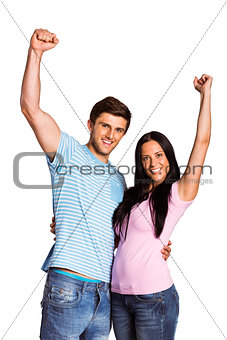 Young couple cheering at camera