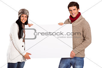 Young couple holding a poster