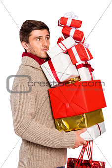 Young man with many christmas presents