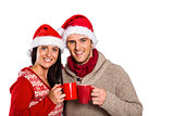 Young festive couple holding mugs