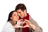 Young couple making heart with hands