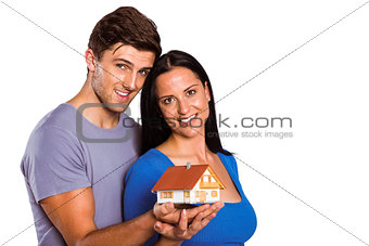 Young couple holding a model house
