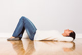 Young woman lying on floor thinking