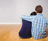 Young couple sitting on floor