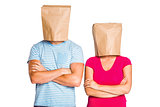 Young couple with bags over heads