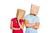 Young couple with bags over heads