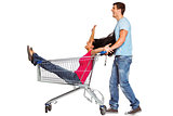 Young couple having fun with shopping cart