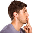 Young man with finger on lips