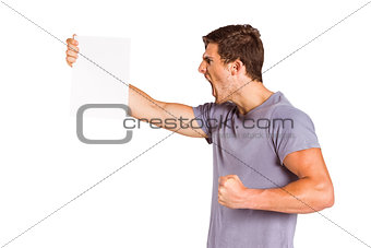 Angry man shouting at piece of paper